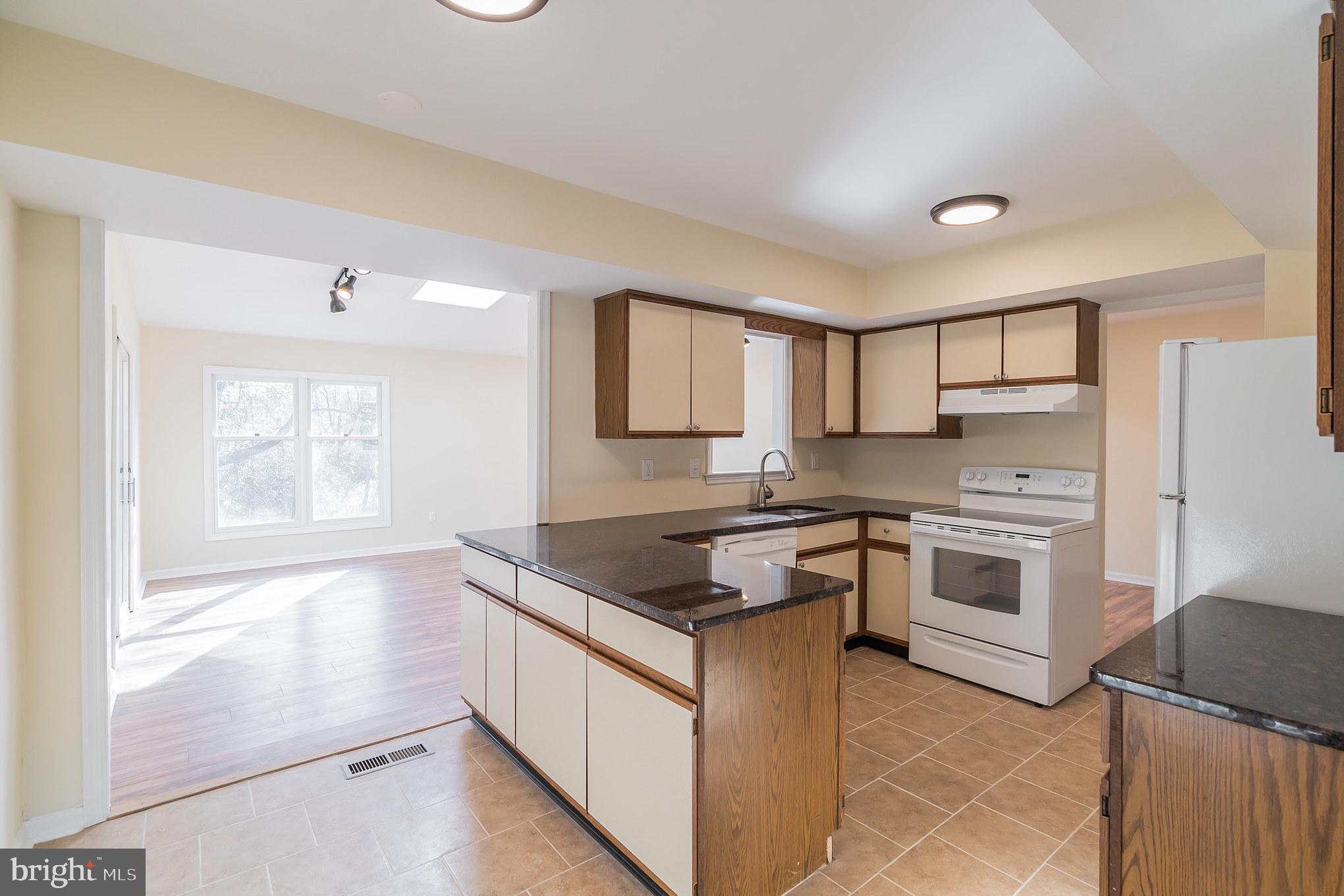 414 Windsor Circle Exton, PA 19341 - Photo 12 of 28 a kitchen with stainless steel appliances granite countertop a stove a sink and a refrigerator