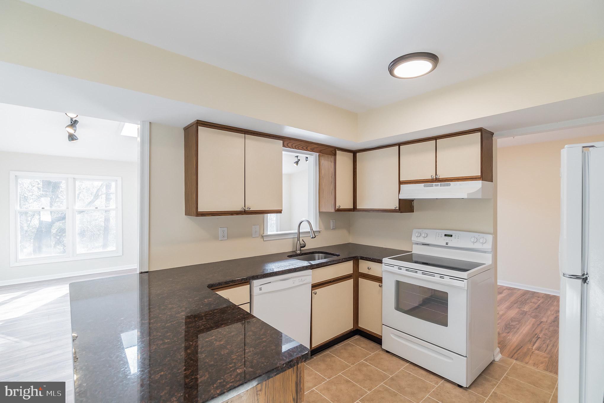 414 Windsor Circle Exton, PA 19341 - Photo 15 of 28 a kitchen with a stove a sink and a window