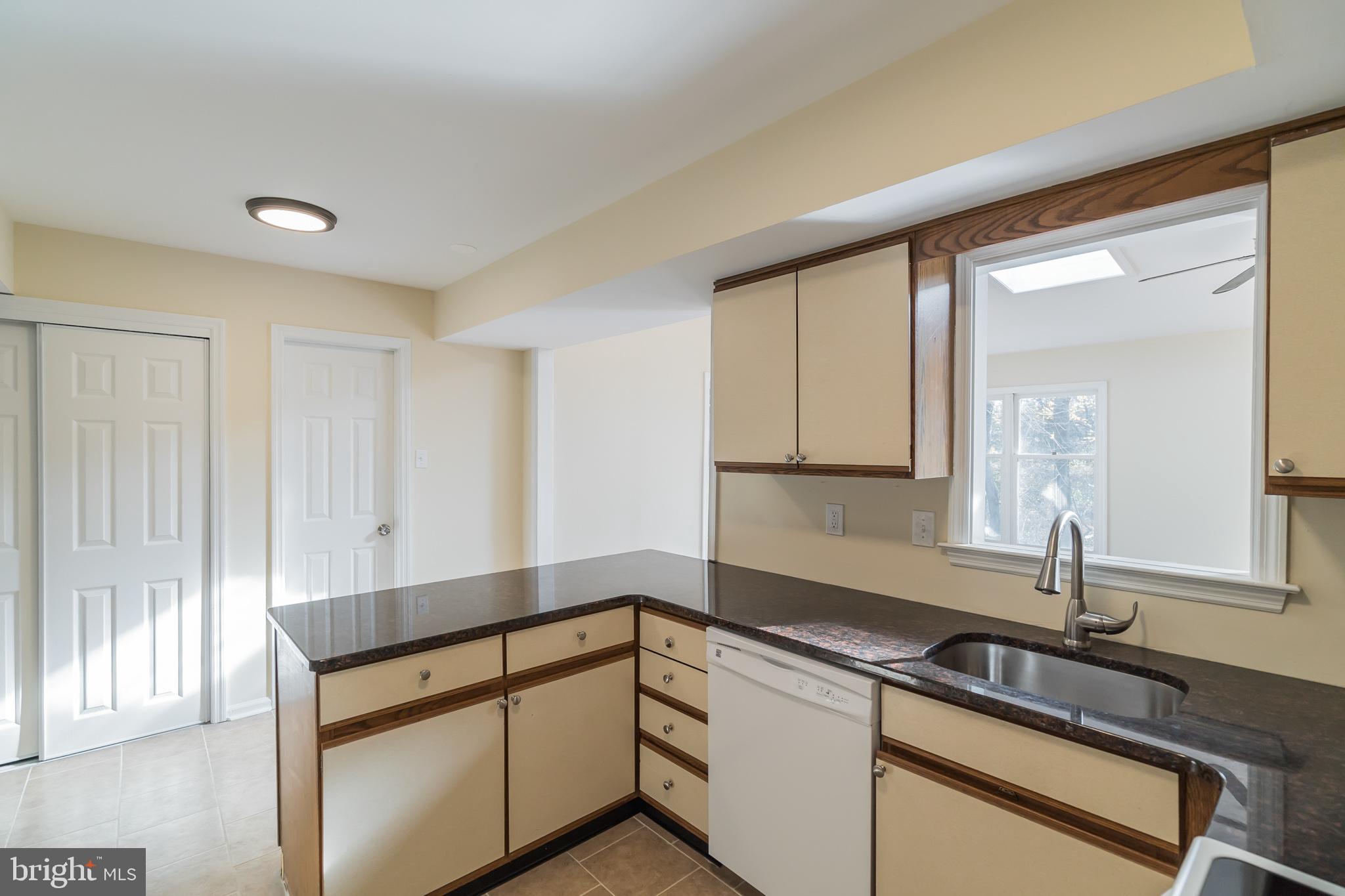 414 Windsor Circle Exton, PA 19341 - Photo 16 of 28 a kitchen with granite countertop white cabinets and a sink