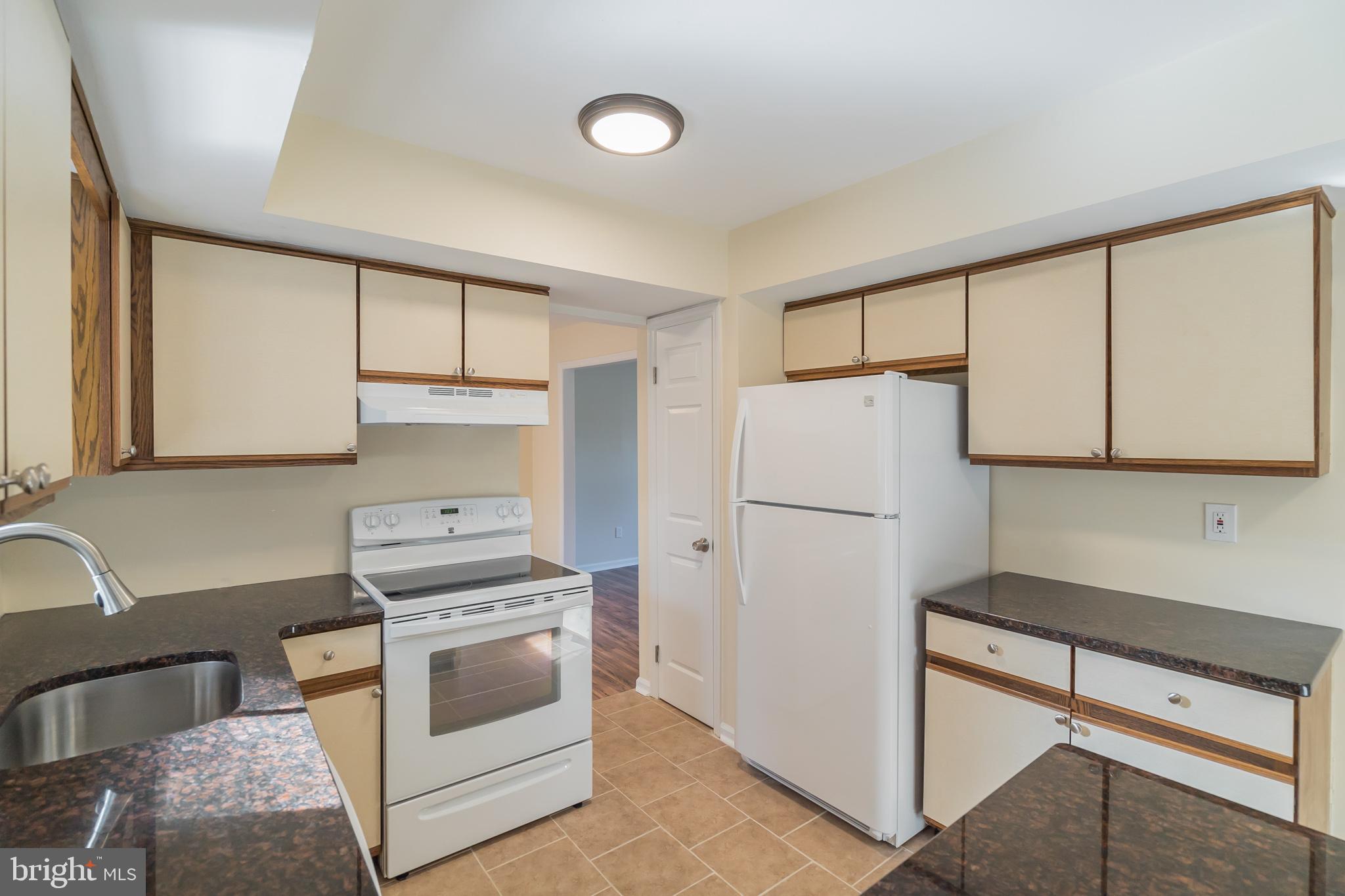 414 Windsor Circle Exton, PA 19341 - Photo 19 of 28 a kitchen with a refrigerator sink stove and cabinets