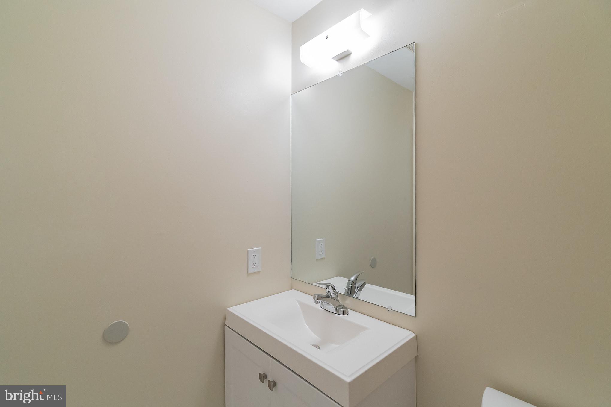 414 Windsor Circle Exton, PA 19341 - Photo 22 of 28 a bathroom with a sink and mirror