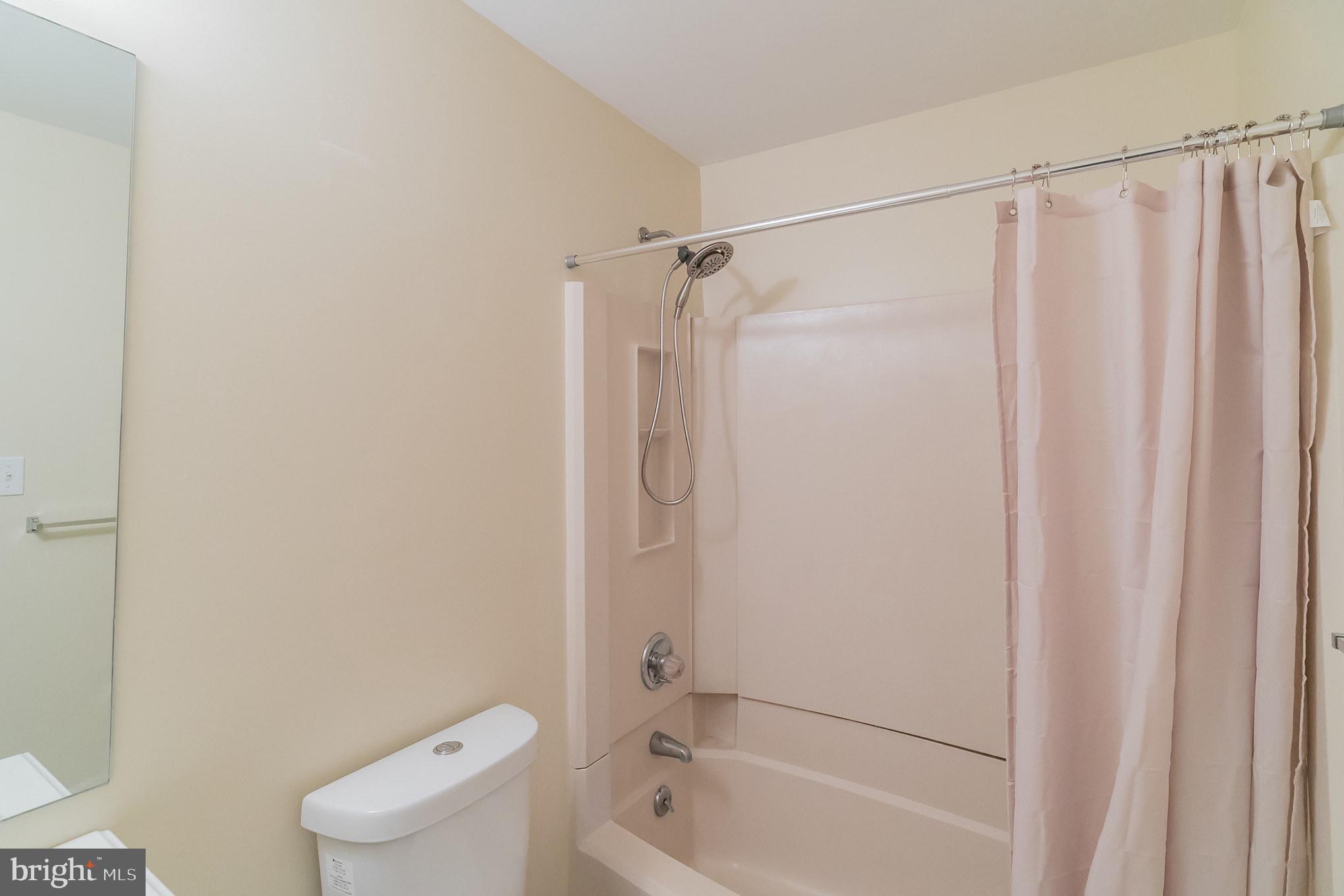 414 Windsor Circle Exton, PA 19341 - Photo 23 of 28 a bathroom with a shower a toilet and a tub