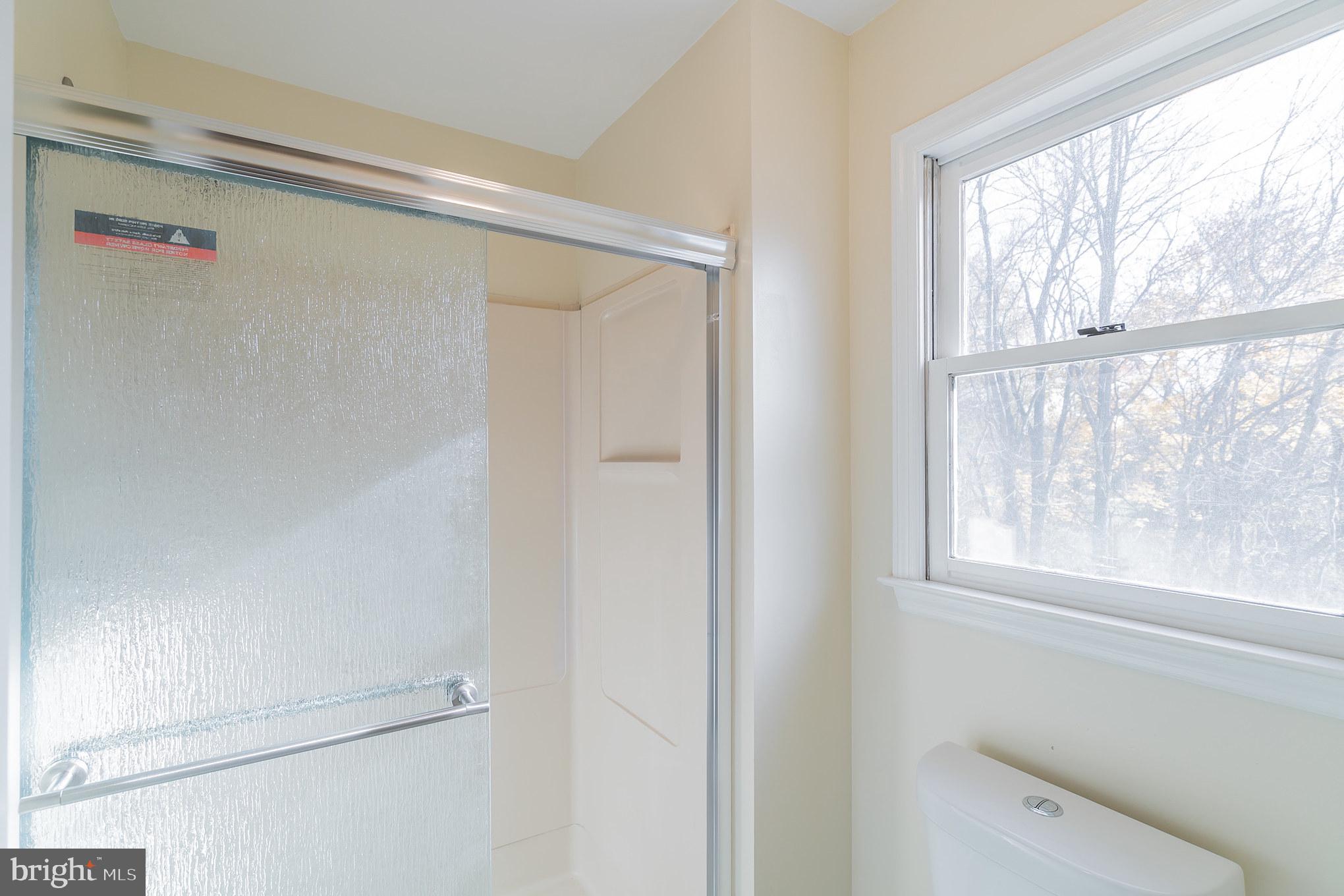 414 Windsor Circle Exton, PA 19341 - Photo 26 of 28 a bathroom with a shower and a window