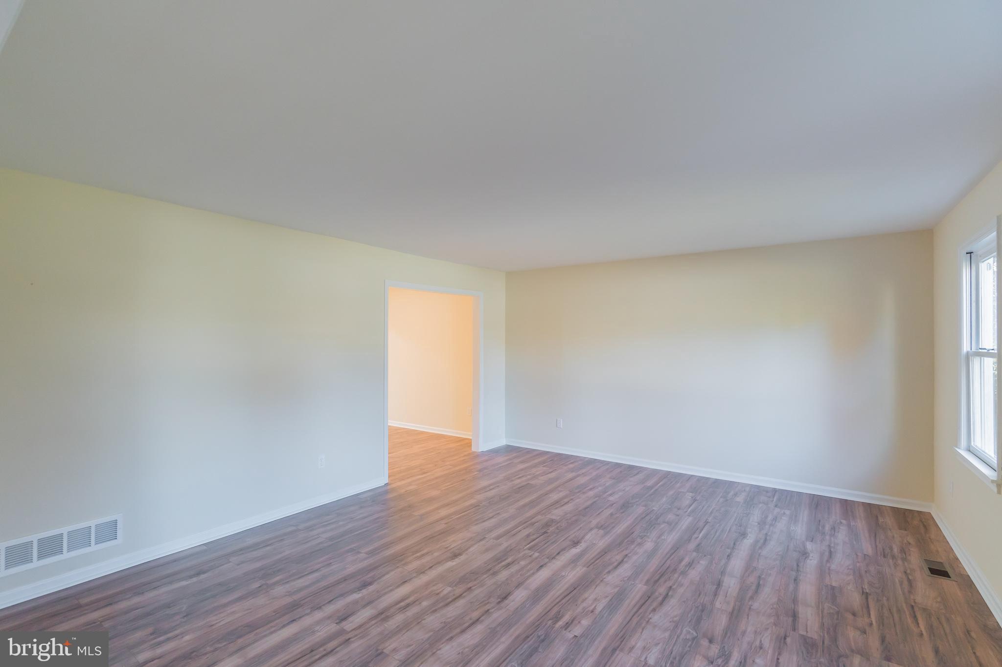 414 Windsor Circle Exton, PA 19341 - Photo 27 of 28 a view of an empty room with wooden floor and a window