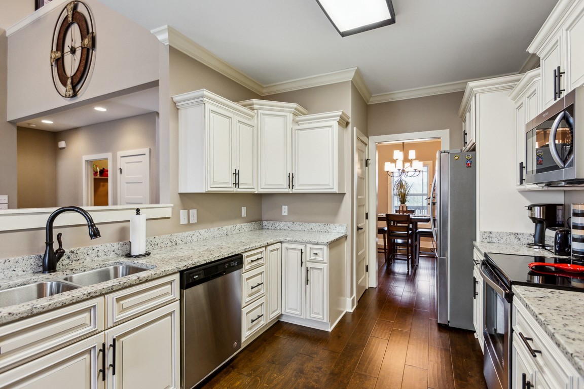 714 Pebble Point Road Lebanon, TN 37087 - Photo 14 of 45 a kitchen with stainless steel appliances granite countertop a sink stove and cabinets
