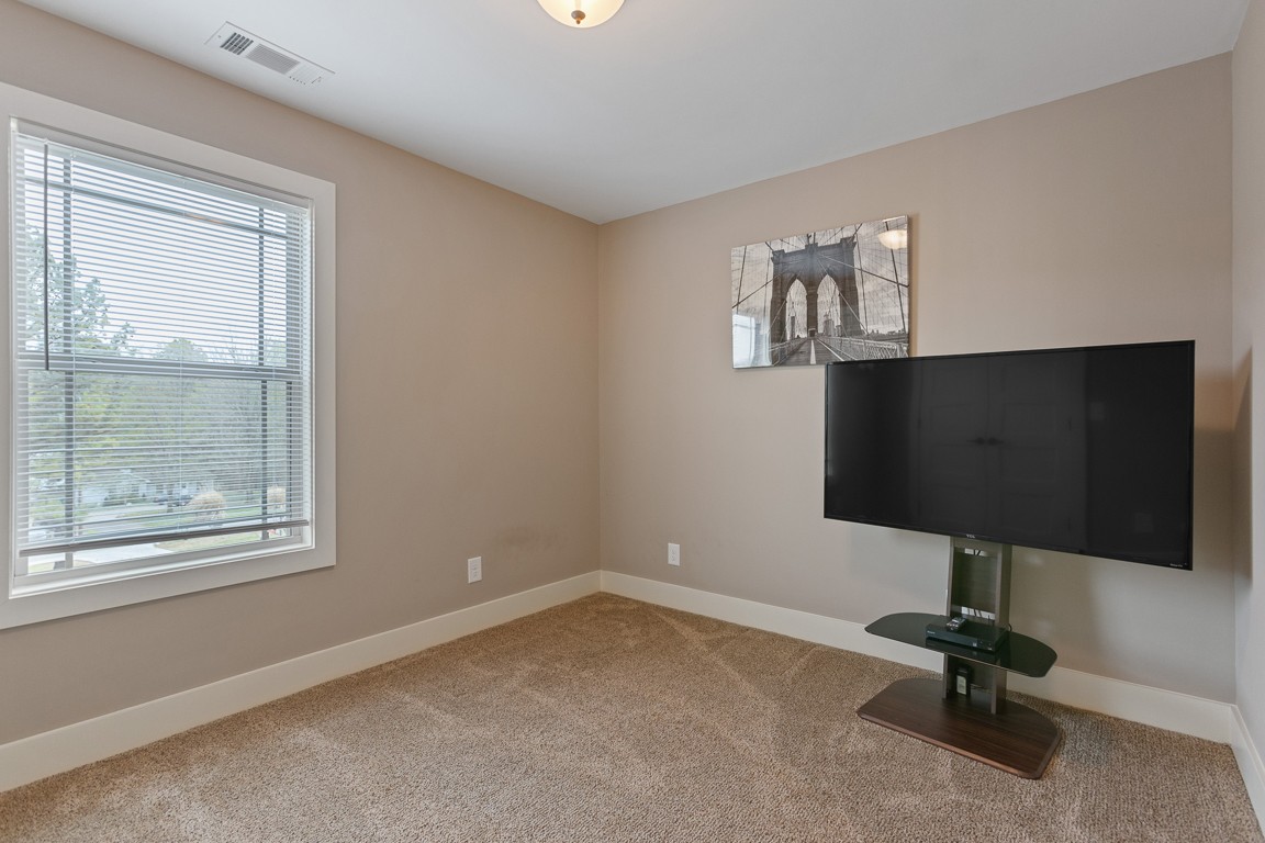 714 Pebble Point Road Lebanon, TN 37087 - Photo 31 of 45 a room with gym equipment and a flat screen tv