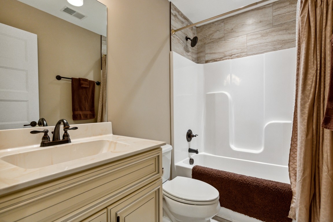 714 Pebble Point Road Lebanon, TN 37087 - Photo 33 of 45 a bathroom with a sink a toilet a mirror a vanity and shower