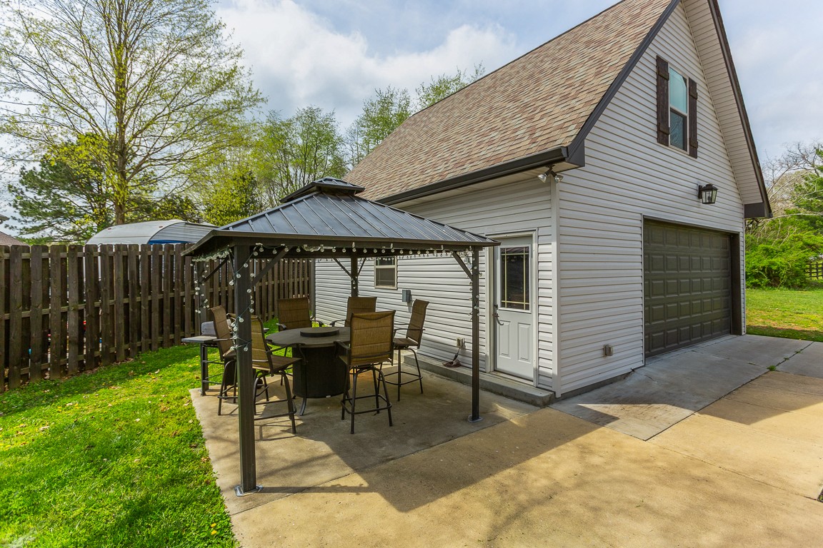 714 Pebble Point Road Lebanon, TN 37087 - Photo 44 of 45 a view of patio with table and chairs under an umbrella