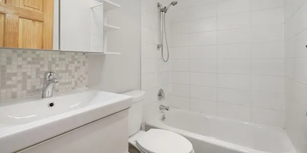 a bathroom with a bathtub and a toilet