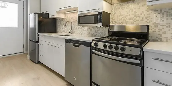 a kitchen with granite countertop cabinets and steel stainless steel appliances