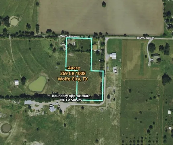 a view of yard with ocean and trees in the background