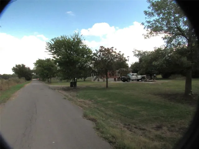 a view of a swimming pool with a yard
