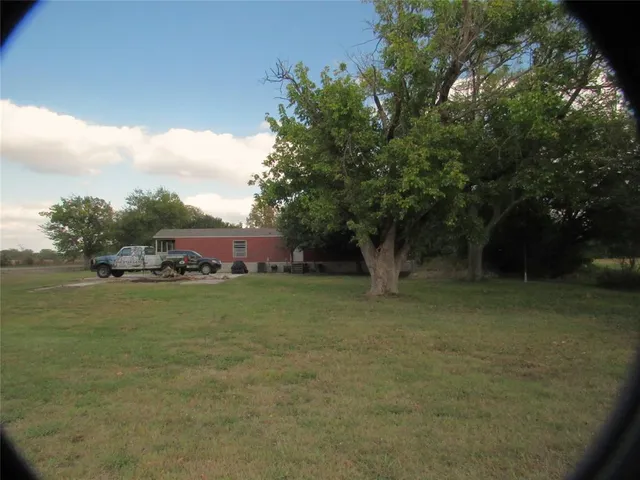 a view of a swimming pool with a yard