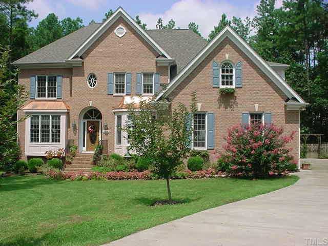 5805 Rock Canyon Road Raleigh, NC 27613 - Photo 1 of 1 a front view of a house with a yard and trees