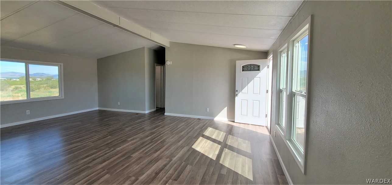 3841 North Avra Road Golden Valley, AZ 86413 - Photo 6 of 78 a view of empty room with wooden floor and fan