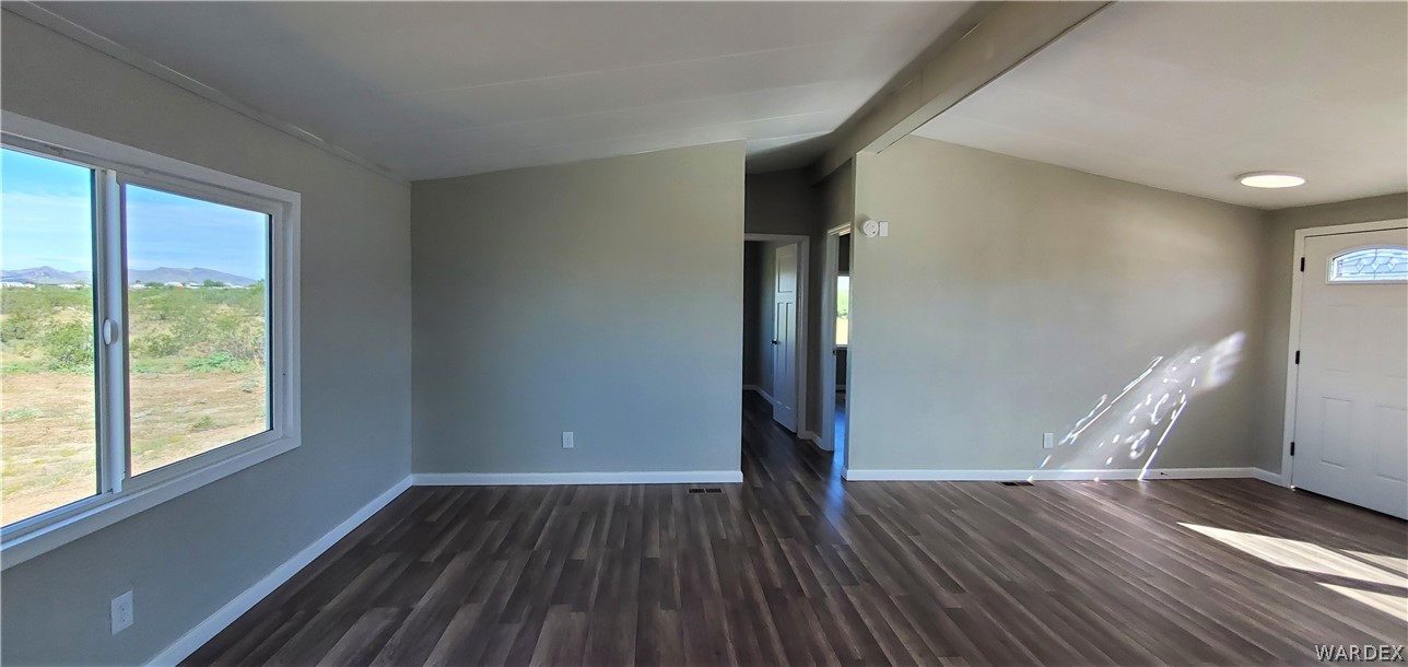 3841 North Avra Road Golden Valley, AZ 86413 - Photo 8 of 78 a view of empty room with wooden floor and fan