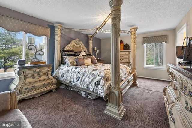 a bedroom with a bed and a tv on table