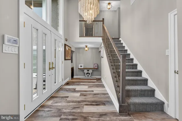 a view of entryway and hall with wooden floor