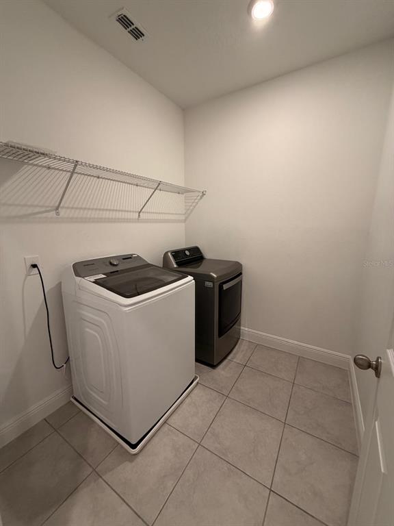 2237 Shadowland Loop Winter Park, FL 32792 - Photo 18 of 20 a utility room with dryer and washer