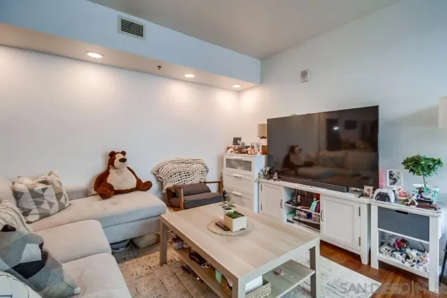 a living room with furniture and a book shelf