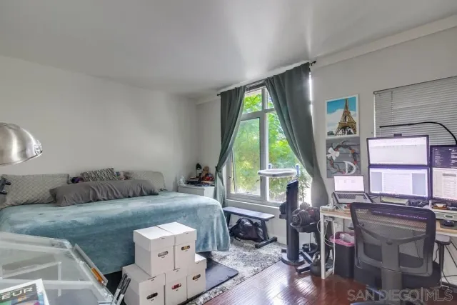 a living room with furniture a table and wooden floor