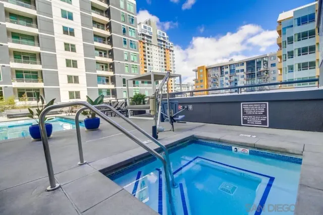 a view of a swimming pool with outdoor seating
