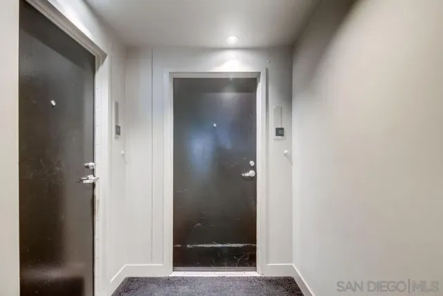 a living room with furniture a flat screen tv and a clock