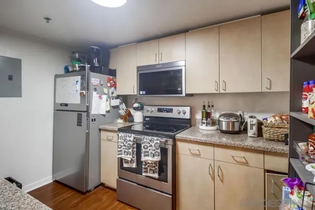 a kitchen with stainless steel appliances granite countertop a sink and cabinets