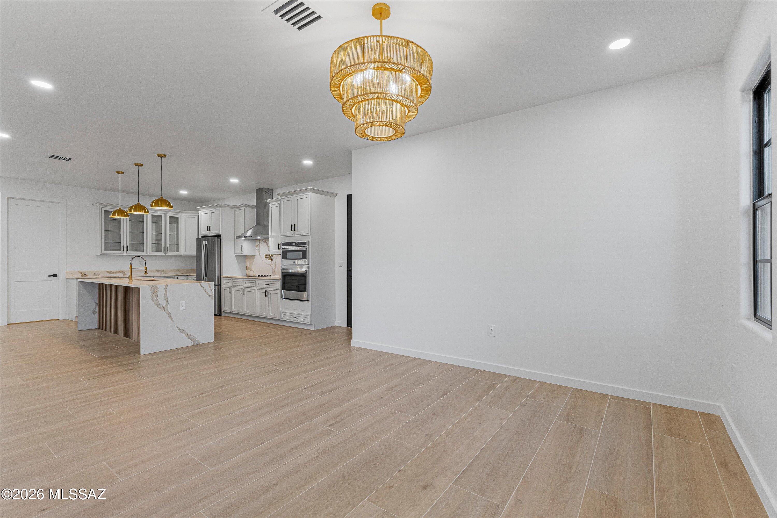 5259 East Fort Lowell Road Tucson, AZ 85712 - Photo 17 of 50 a view of a kitchen with fridge and wooden floor