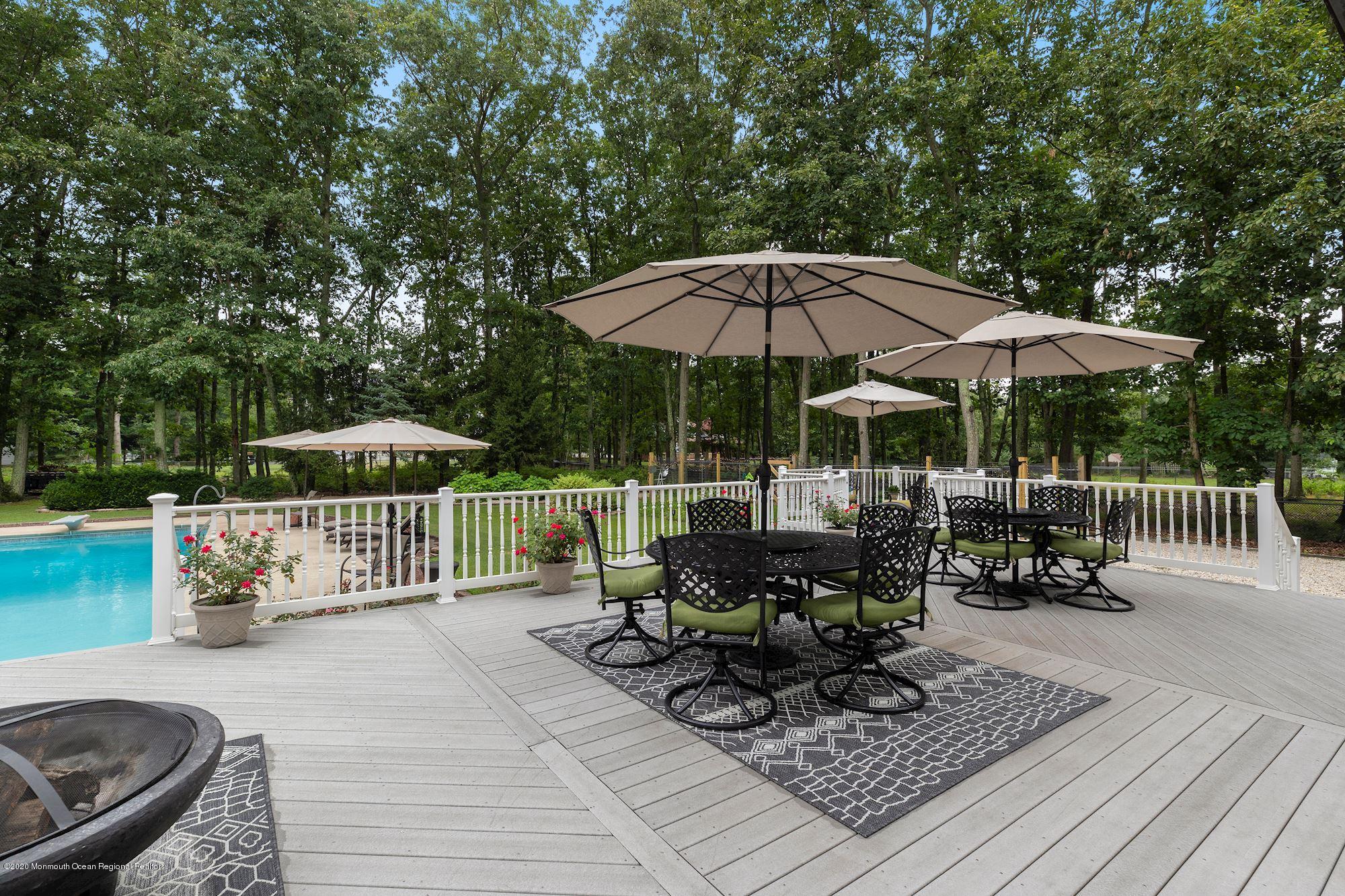 782 Harmony Road Jackson, NJ 08527 - Photo 24 of 25 a view of table and chairs under an umbrella