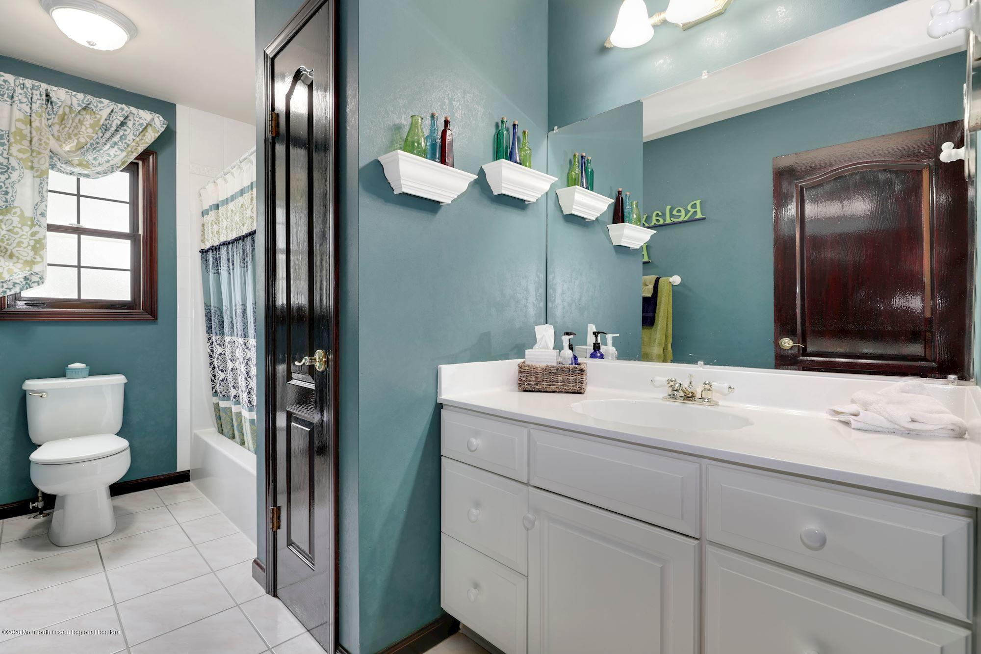 782 Harmony Road Jackson, NJ 08527 - Photo 8 of 25 a bathroom with a sink and a mirror