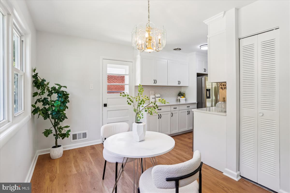 406 Waterford Road Silver Spring, MD 20901 - Photo 11 of 42 a dining room with furniture and a chandelier