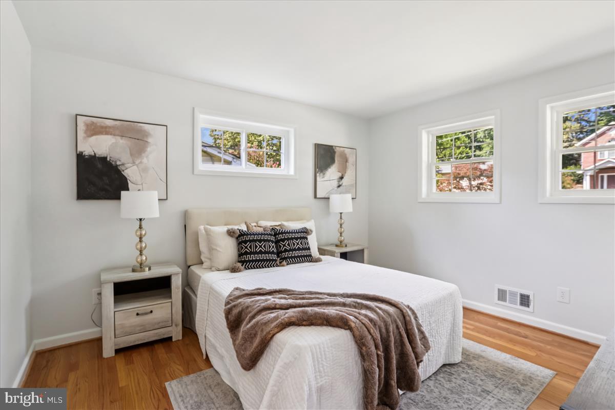 406 Waterford Road Silver Spring, MD 20901 - Photo 15 of 42 a bedroom with a bed and wooden floor