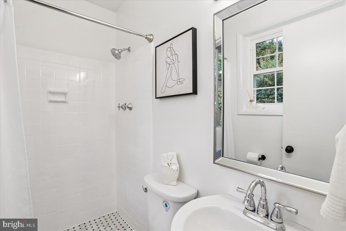 406 Waterford Road Silver Spring, MD 20901 - Photo 17 of 42 a bathroom with a sink and a mirror