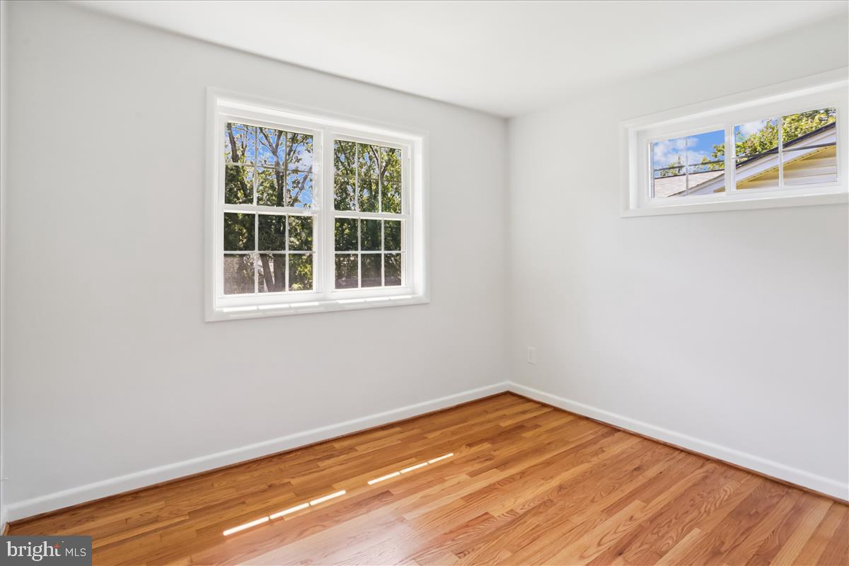 406 Waterford Road Silver Spring, MD 20901 - Photo 20 of 42 a view of empty room with wooden floor and fan