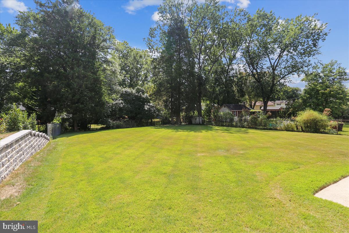 406 Waterford Road Silver Spring, MD 20901 - Photo 2 of 42 a view of swimming pool and trees in the background
