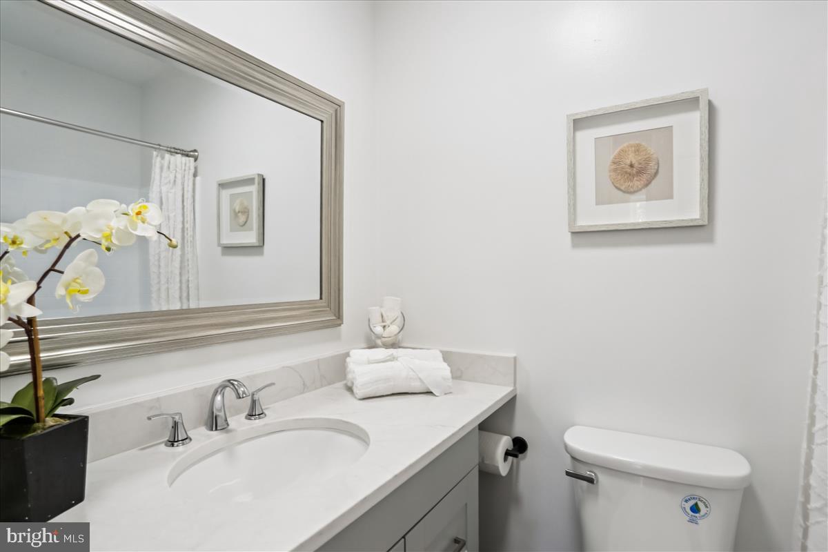406 Waterford Road Silver Spring, MD 20901 - Photo 23 of 42 a bathroom with a sink vanity mirror and toilet