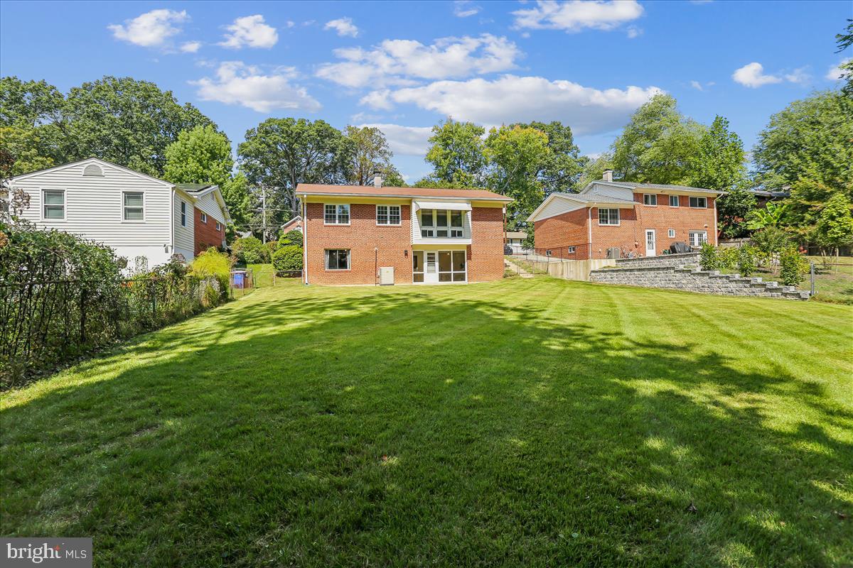 406 Waterford Road Silver Spring, MD 20901 - Photo 28 of 42 a front view of a house with a yard and trees