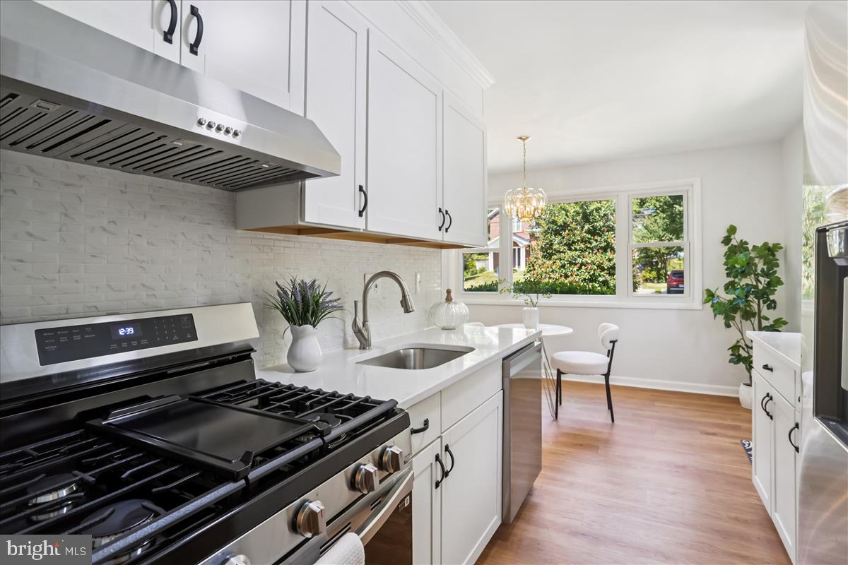 406 Waterford Road Silver Spring, MD 20901 - Photo 9 of 42 a kitchen with a sink a stove and a wooden floor