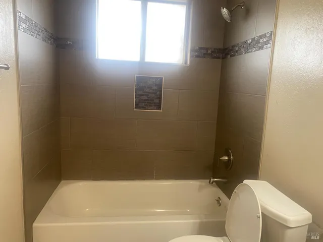 a bathroom with a bathtub and window