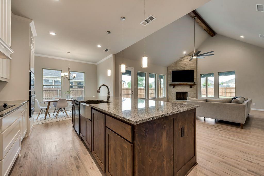 125 Katalina Lane Waxahachie, TX 75165 - Photo 12 of 34 a kitchen with counter top space a sink appliances and wooden floor