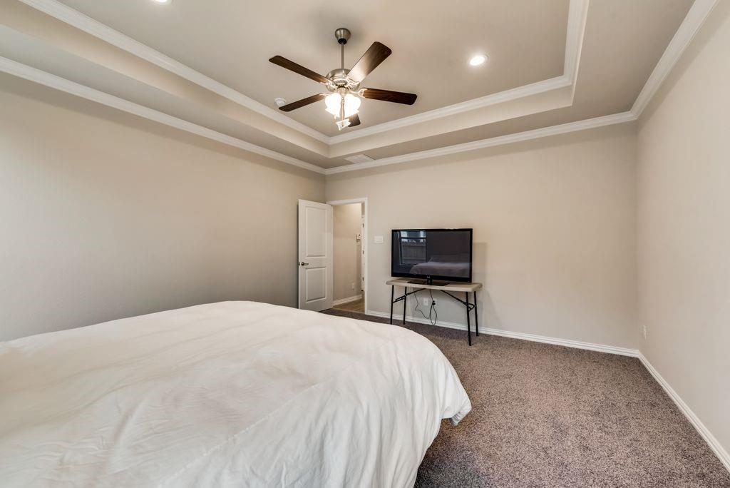 125 Katalina Lane Waxahachie, TX 75165 - Photo 22 of 34 a bedroom with a bed and a flat screen tv