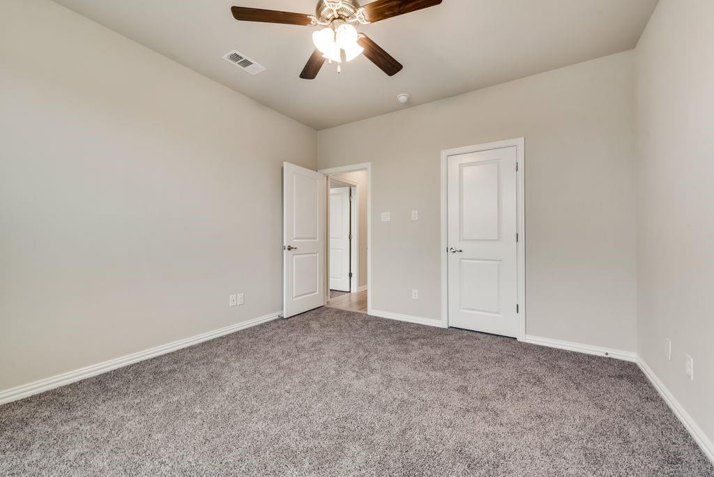 125 Katalina Lane Waxahachie, TX 75165 - Photo 27 of 34 an empty room with chandelier fan