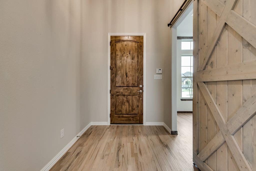 125 Katalina Lane Waxahachie, TX 75165 - Photo 4 of 34 a view of an entryway with wooden floor