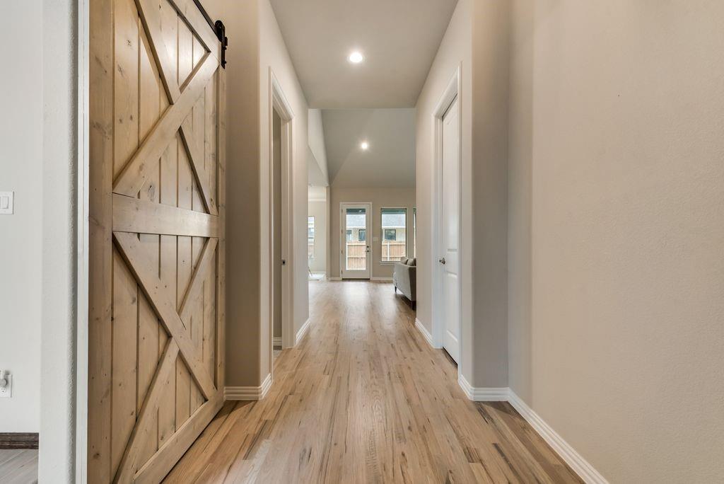 125 Katalina Lane Waxahachie, TX 75165 - Photo 6 of 34 a view of a hallway with wooden floor and staircase