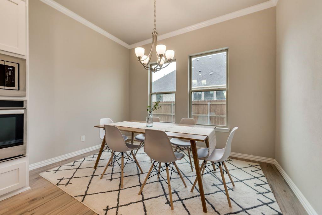 125 Katalina Lane Waxahachie, TX 75165 - Photo 10 of 34 a view of a dining room with furniture wooden floor and chandelier