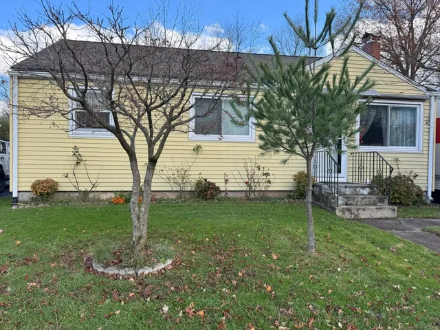 a front view of a house with a yard