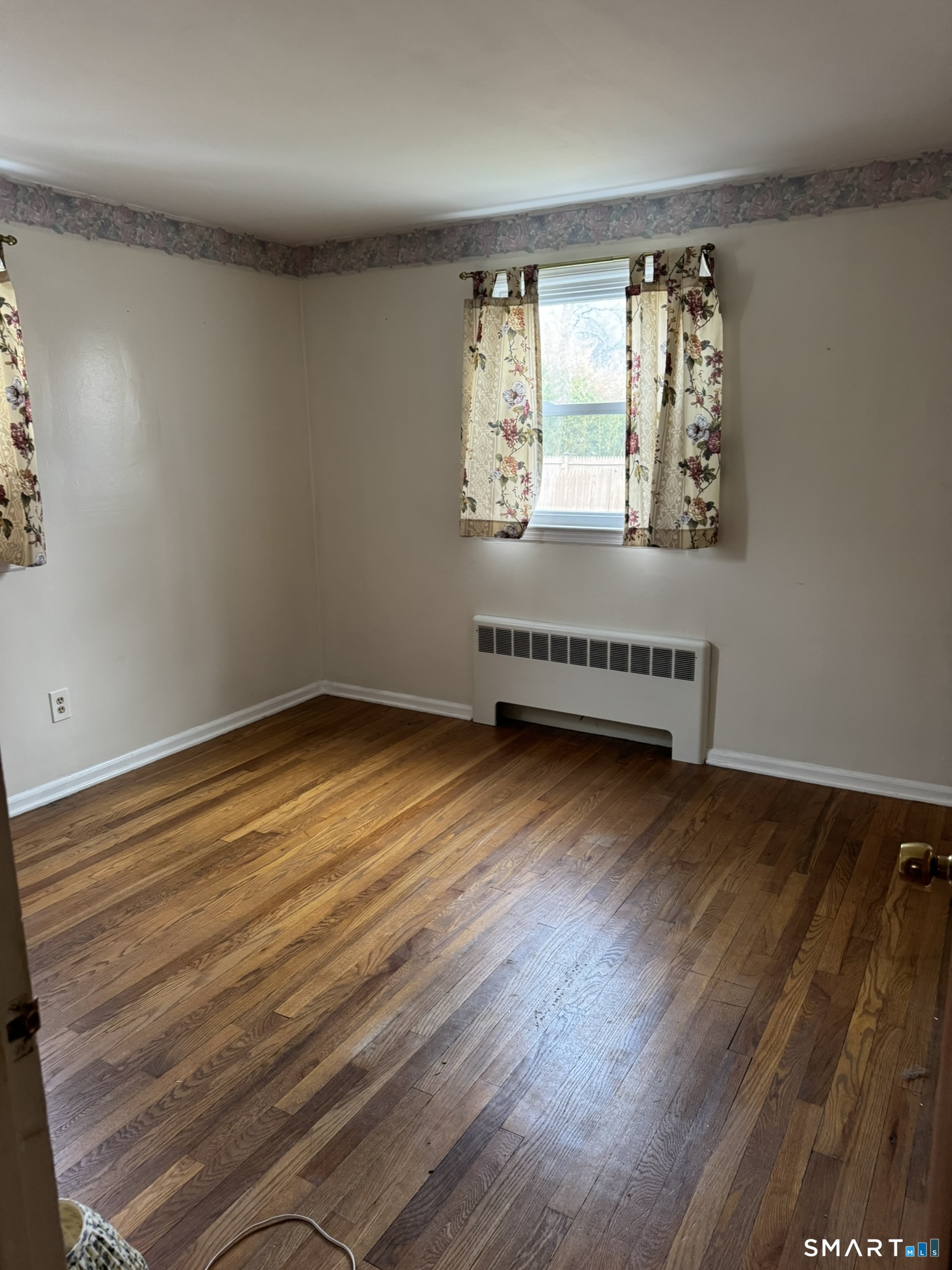 111 Harvard Street Hartford, CT 06106 - Photo 15 of 21 wooden floor in an empty room with a window