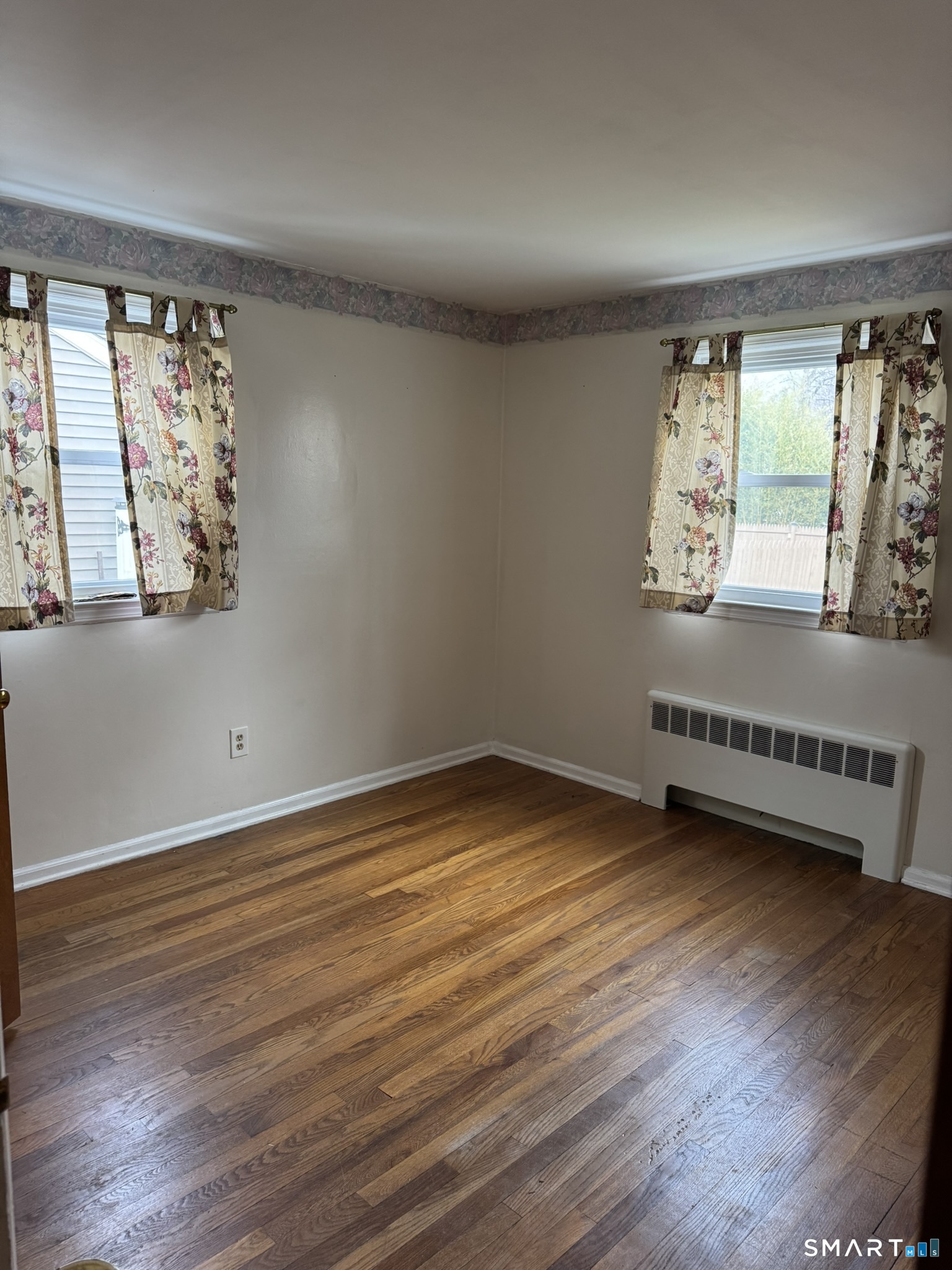 111 Harvard Street Hartford, CT 06106 - Photo 16 of 21 an empty room with wooden floor and windows