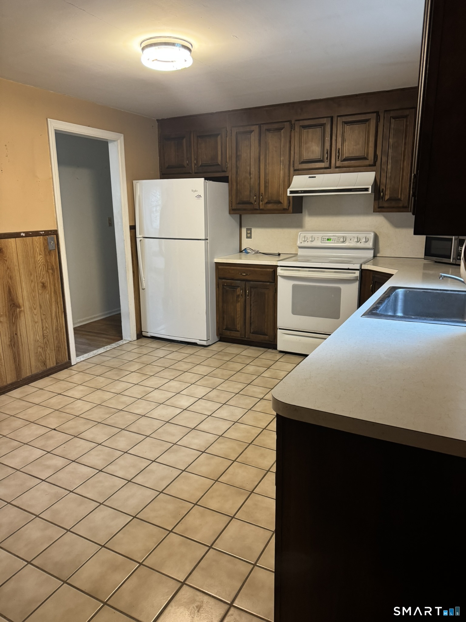 111 Harvard Street Hartford, CT 06106 - Photo 18 of 21 a kitchen with a sink a refrigerator and cabinets